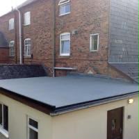 Finished flat roof installation with clean grey membrane
