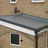 New flat roof with grey membrane and black edge trim